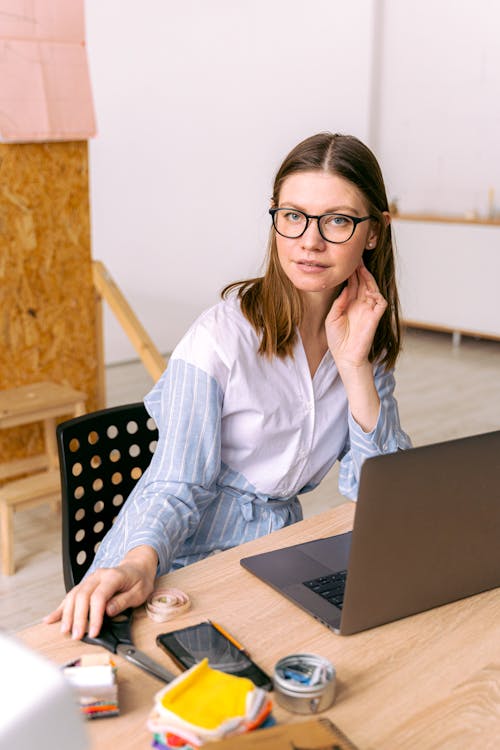 Woman in Blue and White Pinstripe Dress Shirt Wearing Eyeglasses