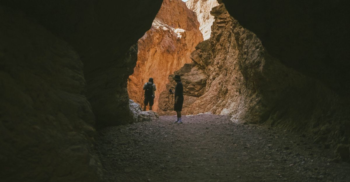 People Exploring Rocks People Exploring a Cave in a Canyon · Free Stock Photo