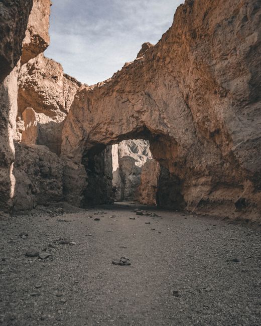 Stunning view of a natural archway in a rocky desert landscape, showcasing the beauty of erosion.