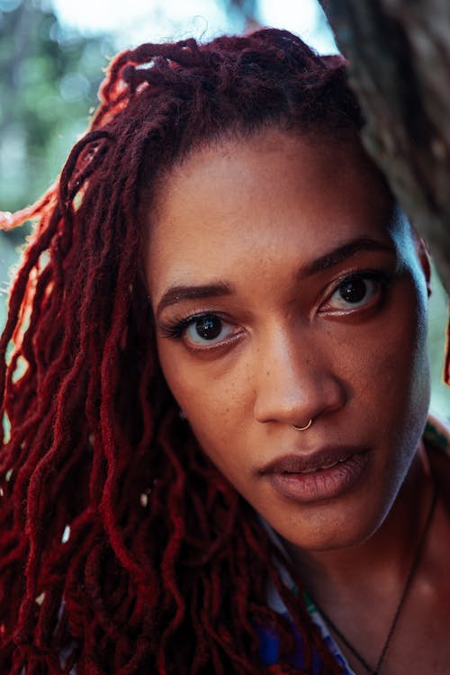 Free Portrait of a Woman with Red Dreadlocks Looking at the Camera Stock Photo
