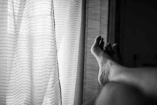 Grayscale Photo of Persons Feet 