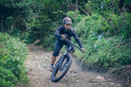 Man in Black Long Sleeve Shirt Riding a Bike 