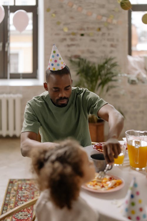 Man in Green Crew Neck T Shirt Wearing Party Hat 