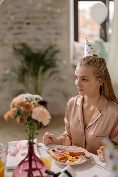 Free Photo of a Woman with Blond Hair Wearing a Party Hat Stock Photo