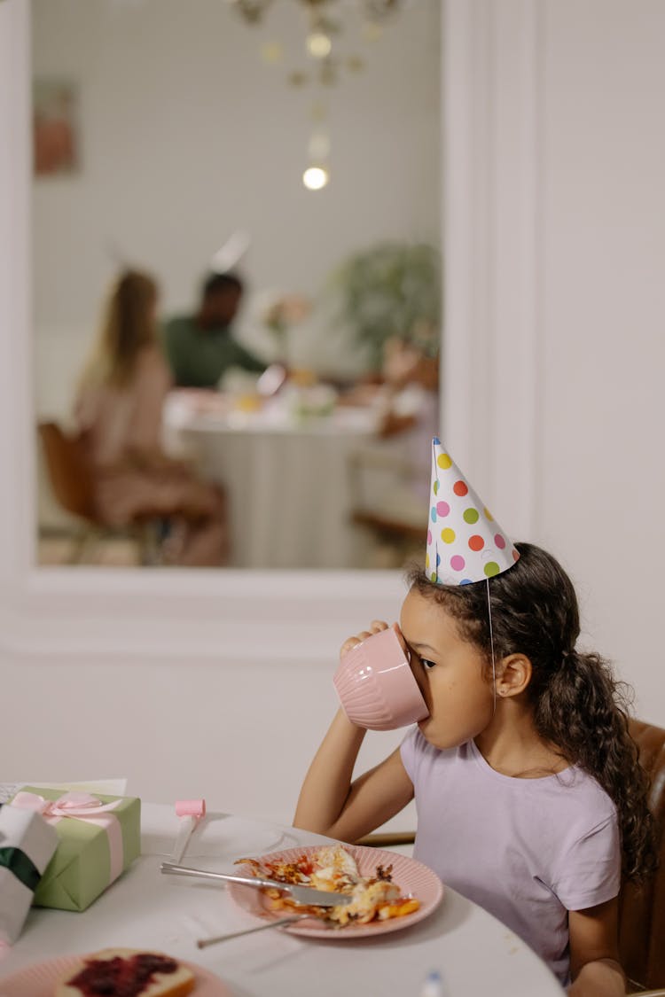 A Girl Drinking From A Mug