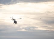 Helicopter and Airplane Flying Over the Clouds