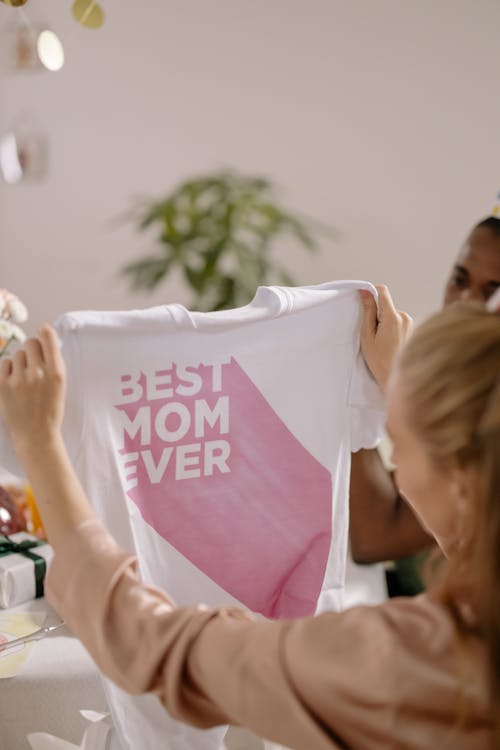 A Woman Looking at a Printed White T-shirt