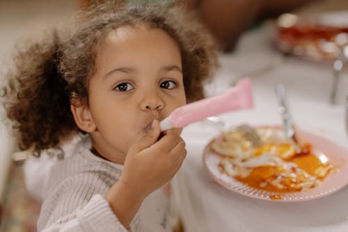 Free Girl with a Party Horn Blower Stock Photo