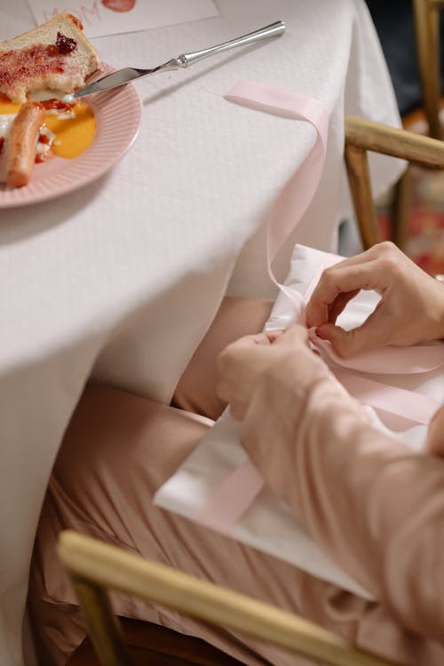 A Close-Up Shot of a Person Opening a Present