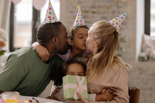 Photograph of a Girl Kissing Her Mother during Her Birthday