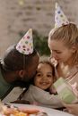 Girl in White and Green Dress Hugging Girl in White and Blue Dress