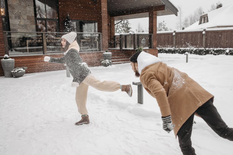 Couple Playing In The Snow