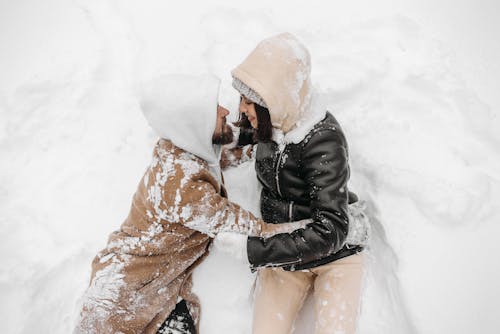 Romantic Couple Lying on Snowy Ground