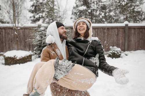 A Man Carrying a Woman During Winter