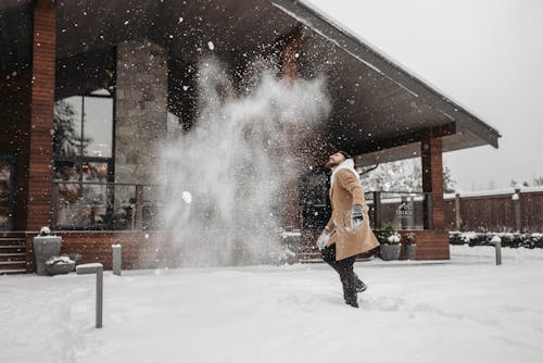 A Man Plying with Snow Outside