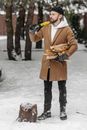 Person in Brown Coat Holding Black Dslr Camera