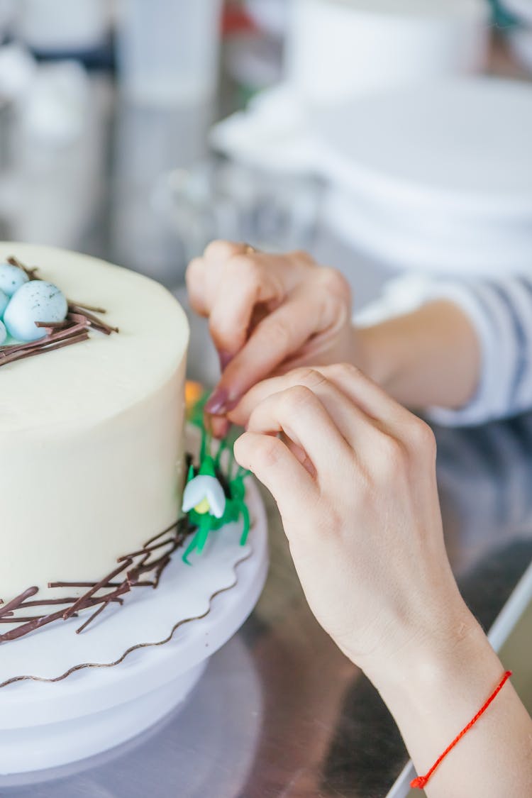 Close Up Of Woman Hands Decorating Birthday Cake