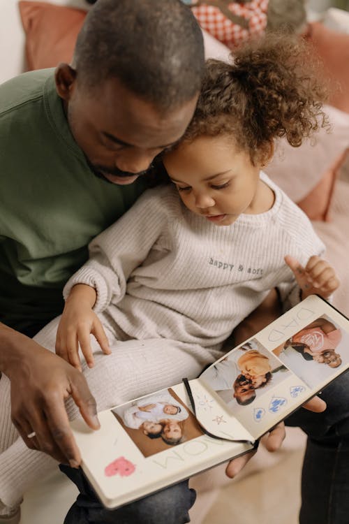 Father and Daughter Looking at Pictures
