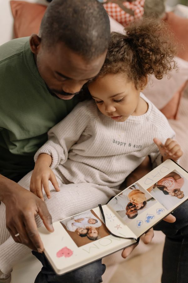 A father and daughter looking at family photographs