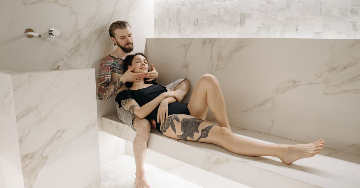 Couple enjoying a serene moment in a stylish, marble-themed spa environment. Ideal for relaxation concepts.