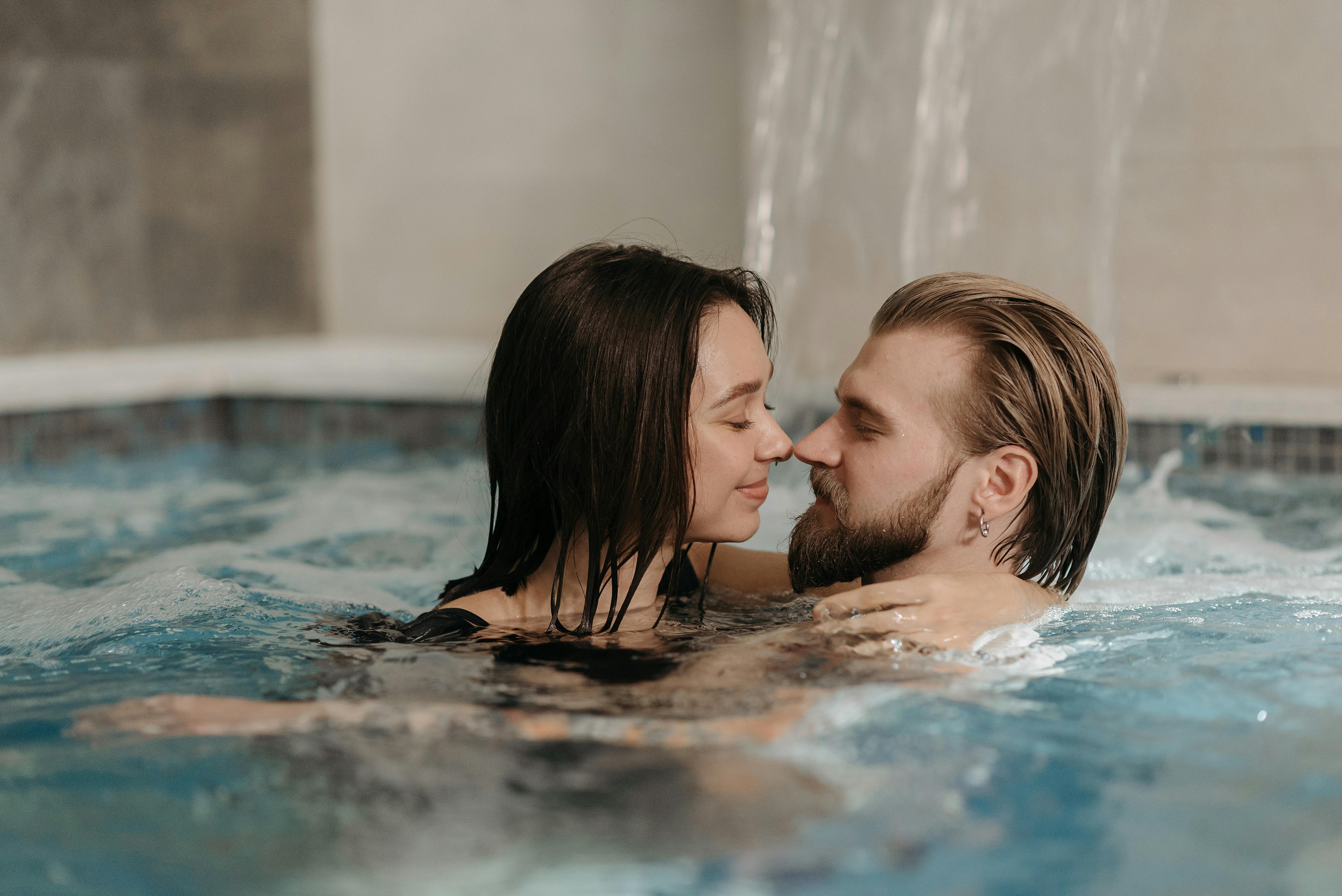 Photo of a Couple Nose to Nose in a Swimming Pool · Free Stock Photo