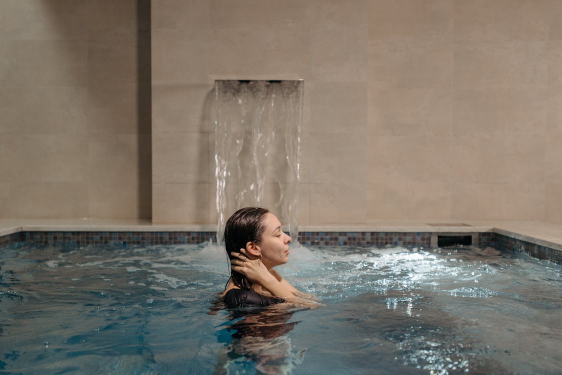 Free A Woman Bathing in a Pool Stock Photo