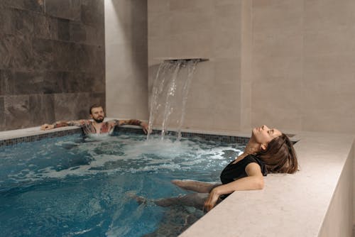 Free A Couple Relaxing in a Pool Stock Photo