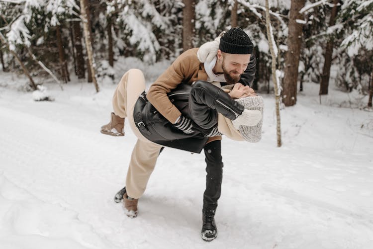 Happy Couple Dancing On Snow 