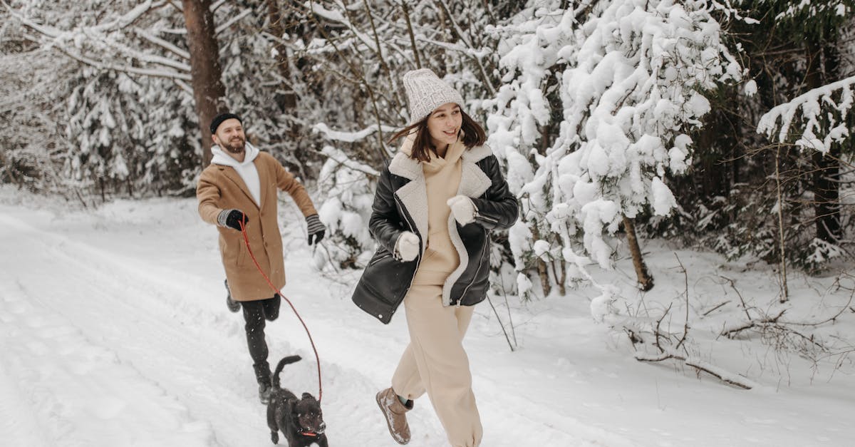 Photograph of a Man and a Woman Running with a Black Dog