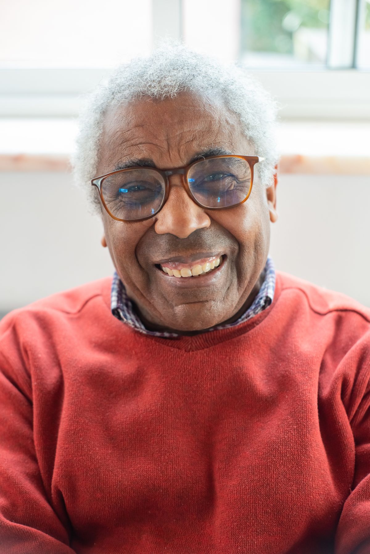 Illustrative older man smiling at home