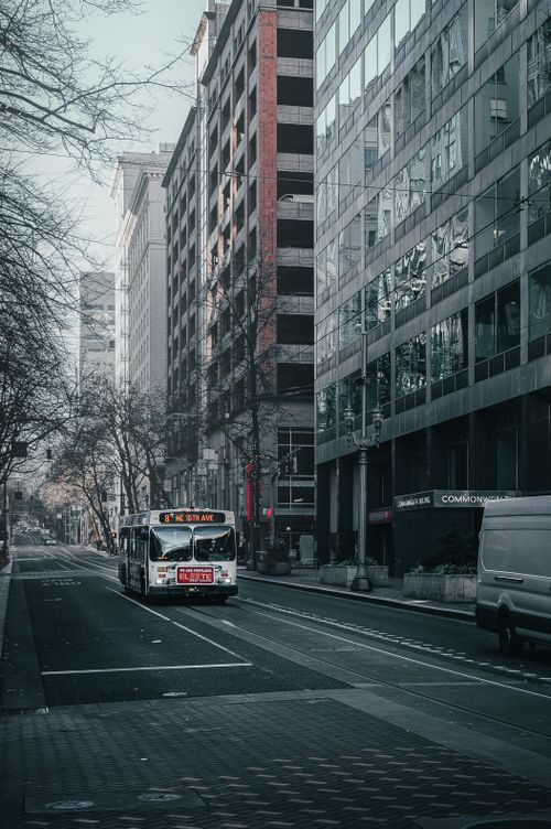 Free Public transport driving on asphalt road near modern commercial buildings in city downtown Stock Photo