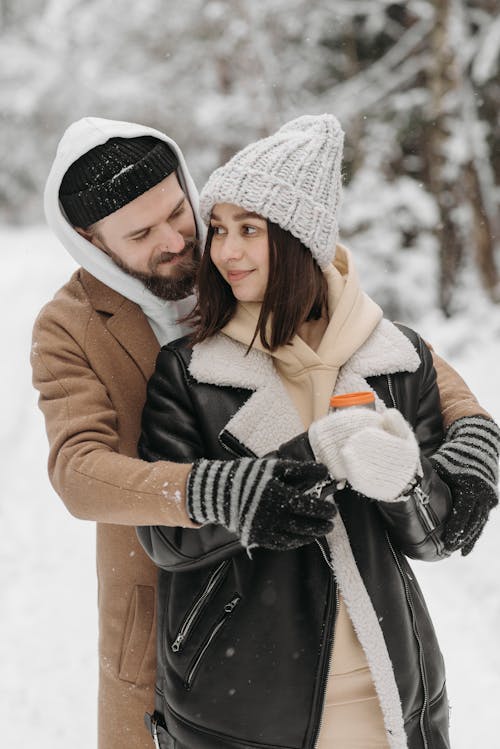 Man and Woman Hugging  During Snow