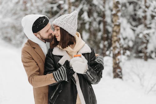 Man Hugging a Woman during Winter