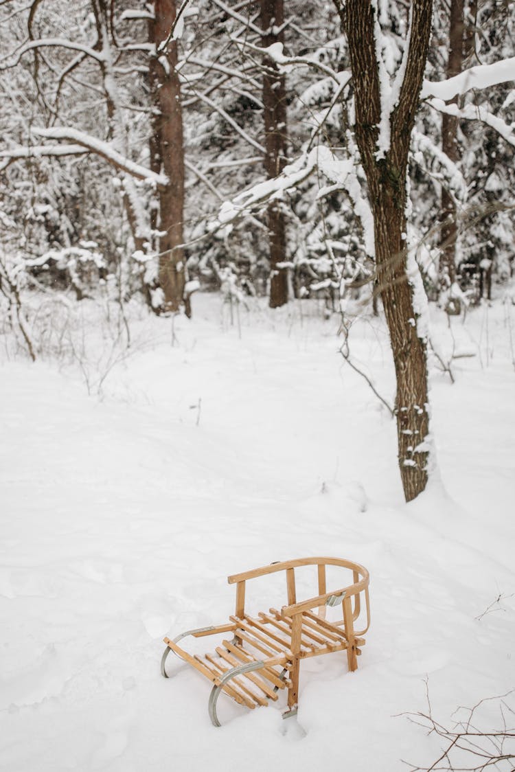 A Wooden Sleigh On A Snow Covered Ground