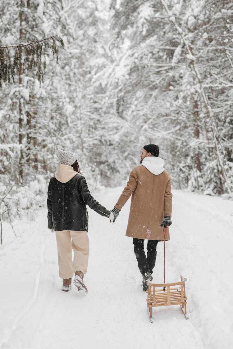 Back View Of A Couple Walking On The Snow