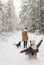 A Man Pulling a Woman on a Sleigh