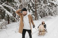 A Man Pulling a Woman on a Sleigh