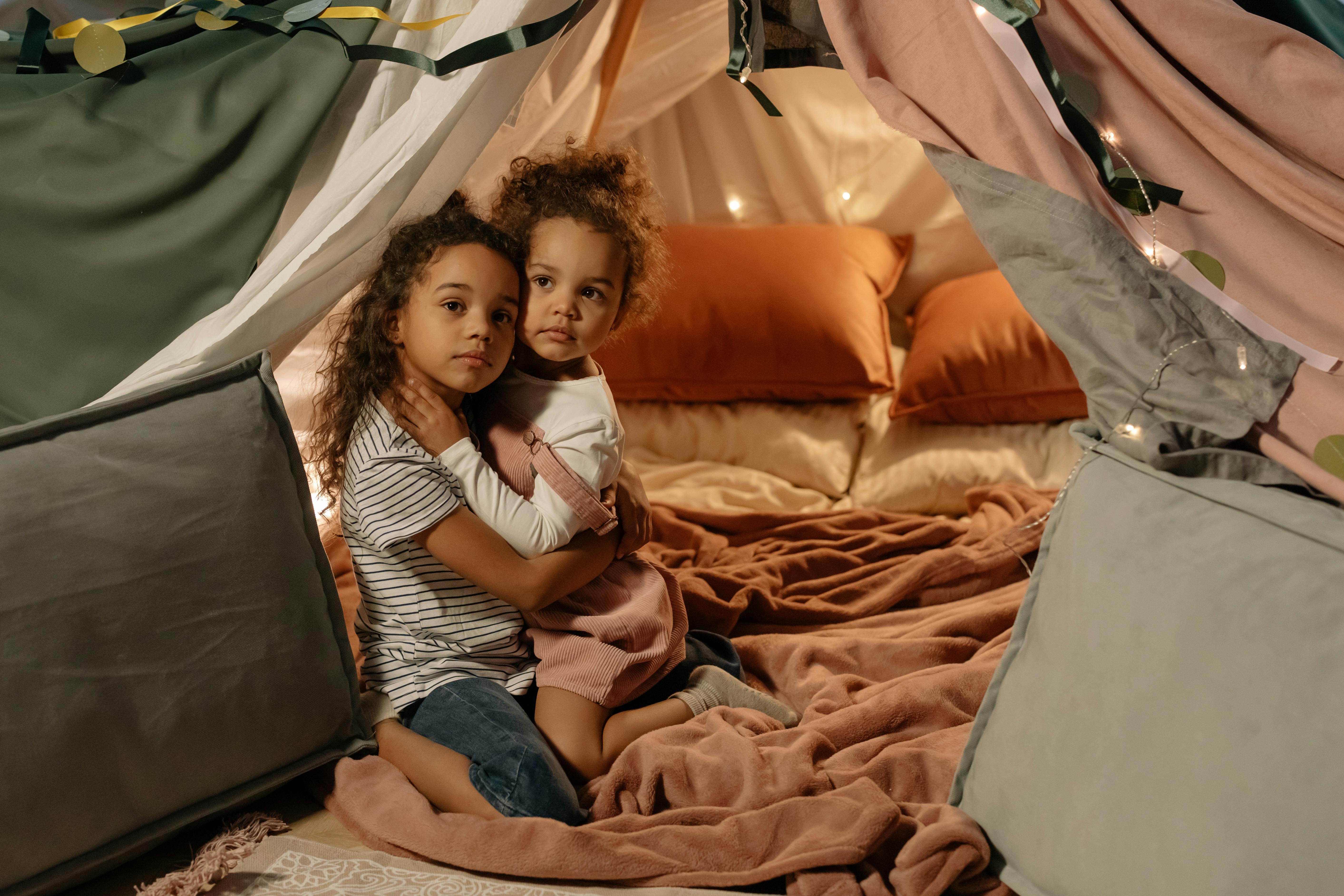 girls hugging in a tent