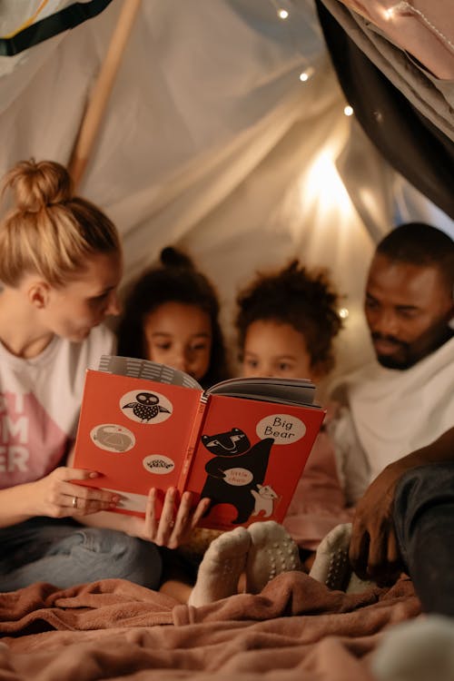 
Parents Reading a Book to Their Children