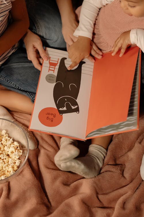 Photo of a Girl Pointing at a Book