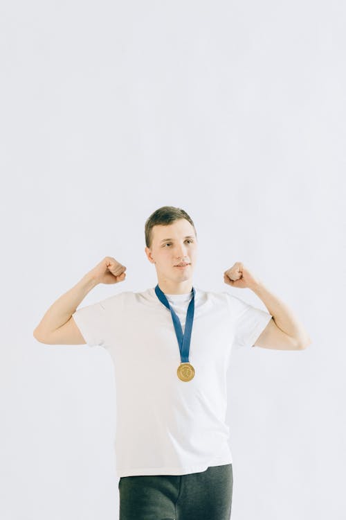 Free Man Wearing  White T-Shirt and a Medallion Stock Photo