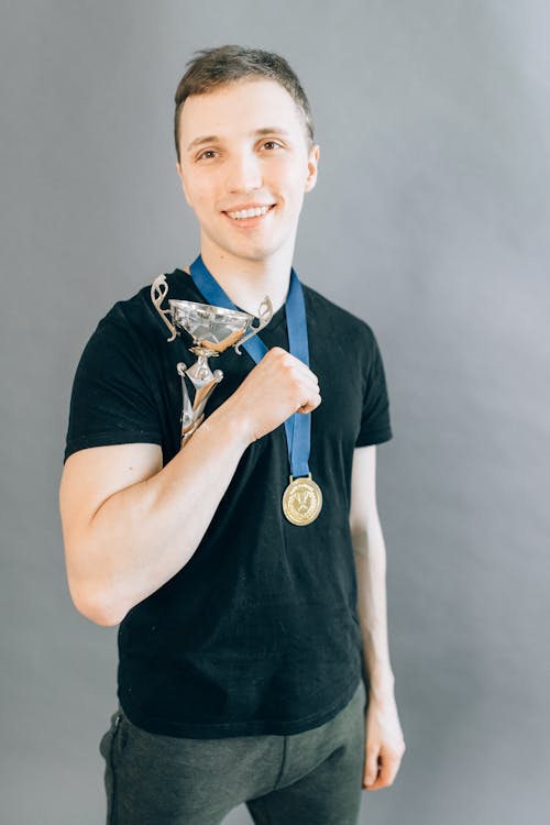 Free Man in Black Crew Neck Shirt Wearing a Medal Stock Photo