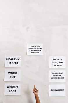 Motivational signs promoting healthy habits and self-awareness with pointing hand.