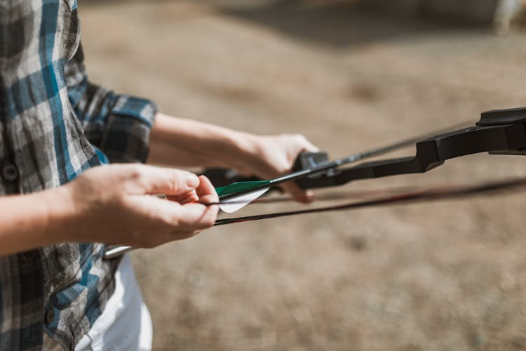 Person Holding A Bow And Arrow