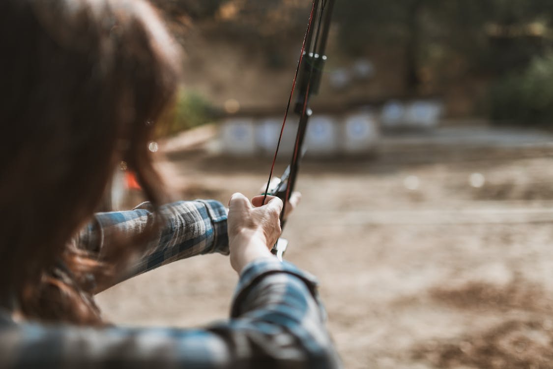 Free Woman Holding a Bow and Arrow Stock Photo