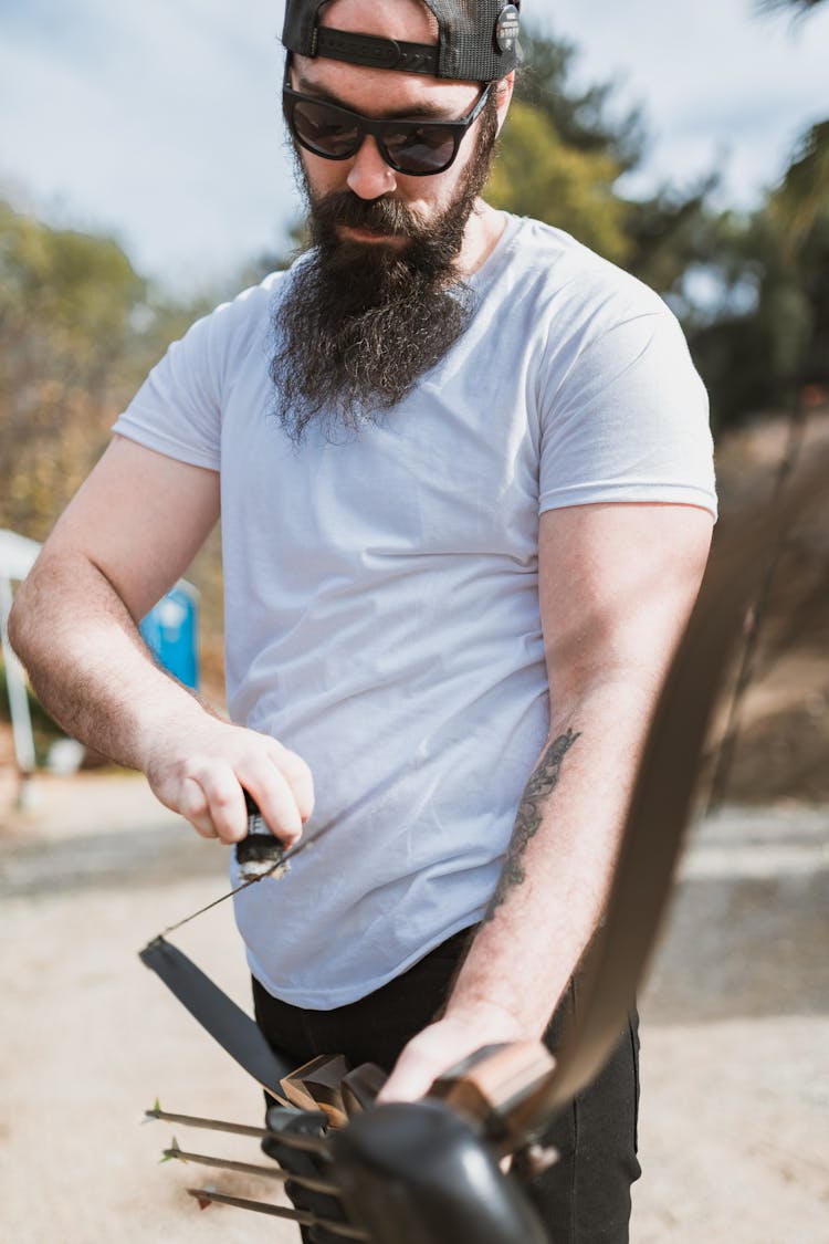 Bearded Man Holding A Bow