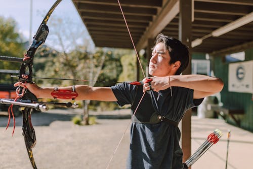 A Male Archer Aiming a Target