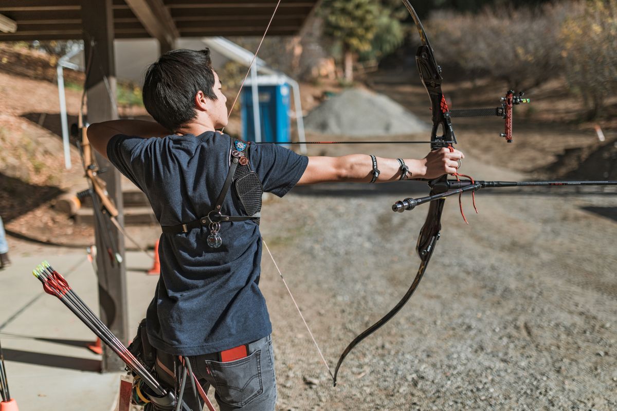 Side view of an archer at full draw on a compound bow