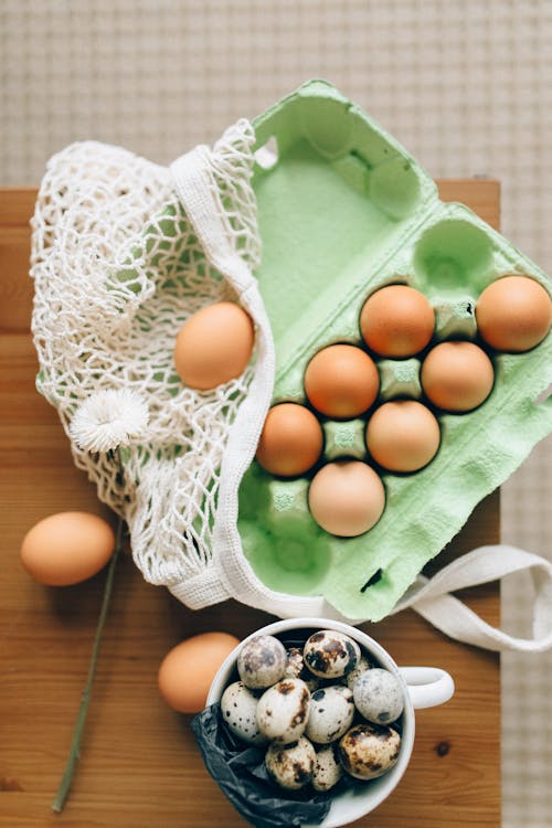 A Brown Eggs on Tray Near the Quail Eggs on Ceramic Mug