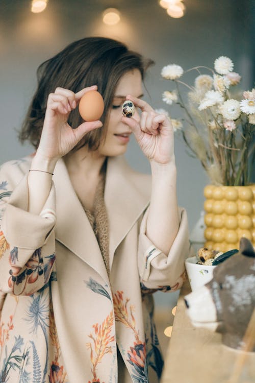 Free A Woman Holding Chicken and Quail Eggs Stock Photo